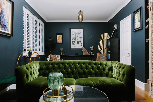 A dramatic but cosy dark blue, green & gold living room