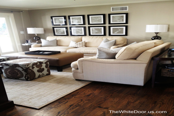 Beige leather sofas, brown leather ottoman, accent poufs with